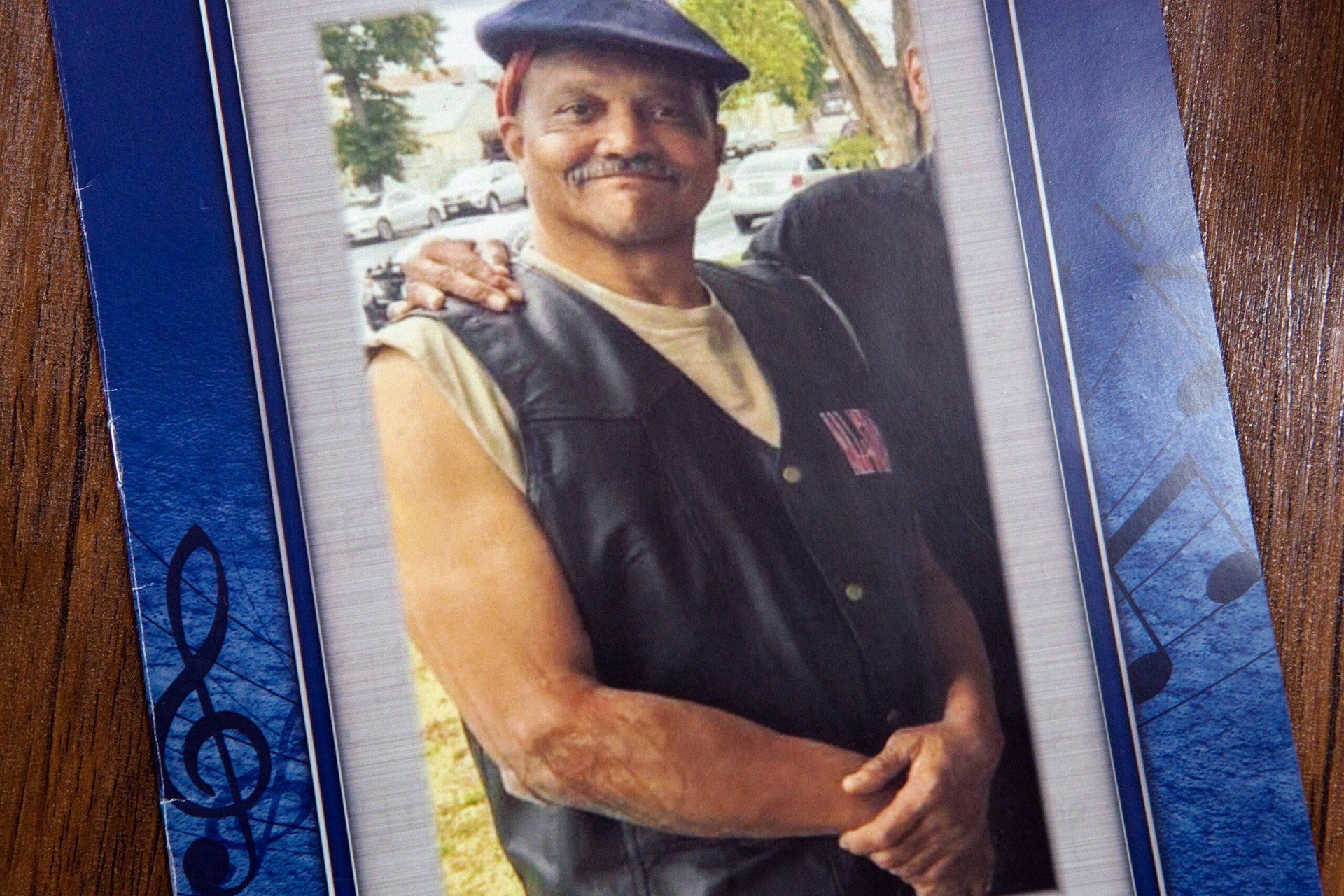 Andre Butler is seen smiling on the cover of his funeral program.