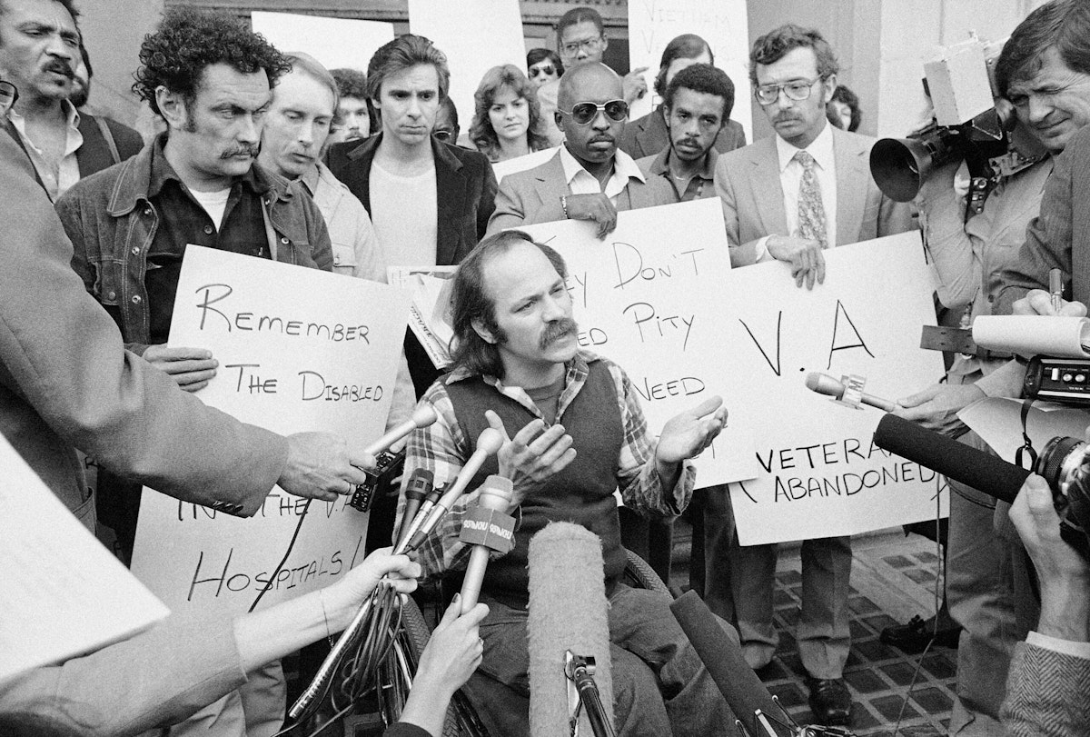 Vietnam Veteran Ron Kovic, in a wheelchair, holds a sidewalk news conference Jan. 30, 1981, in Los Angeles.