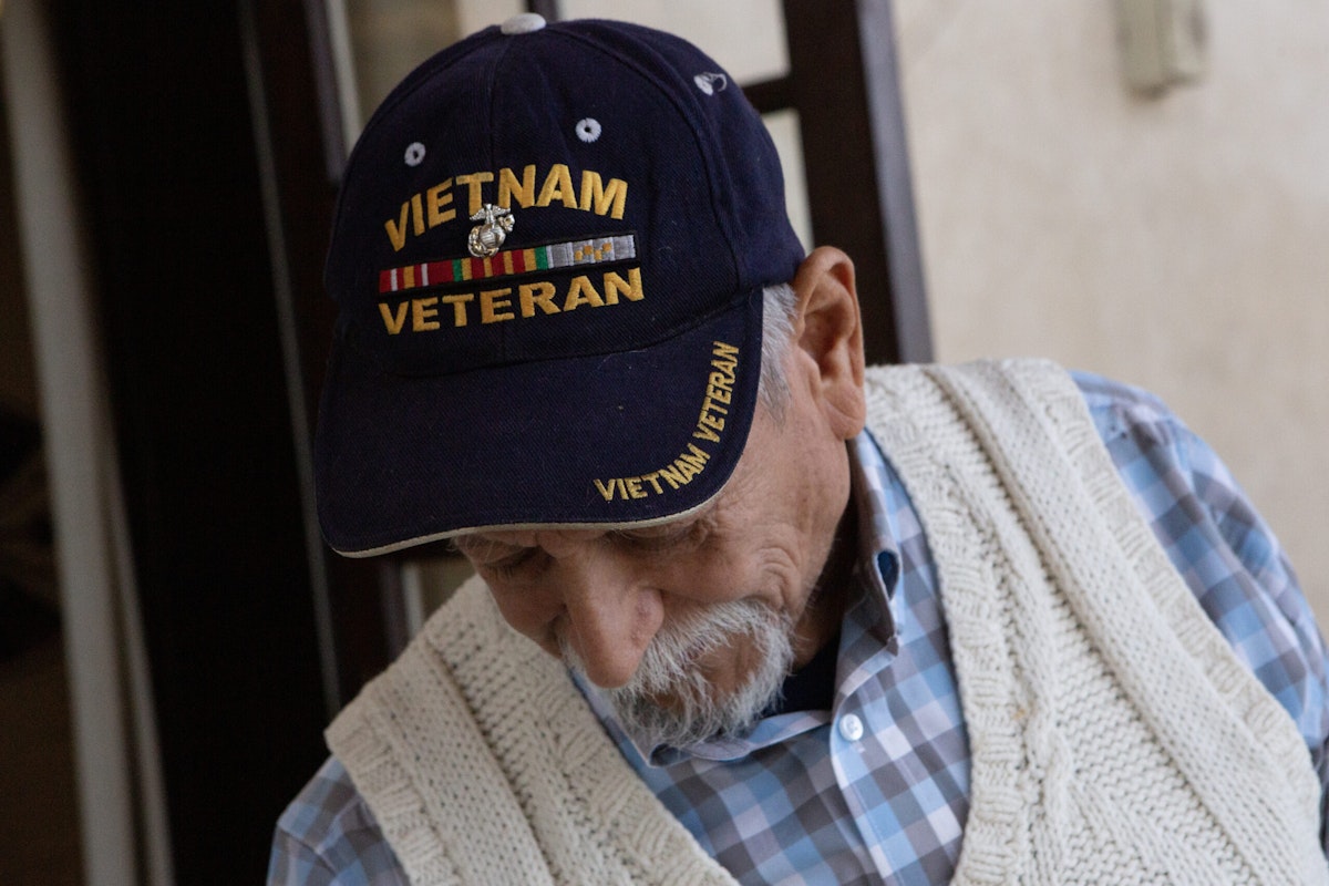 Jesse Jay Morales, wearing a Vietnam veteran hat, poses for a portrait at Patriot Hall in downtown Los Angeles.