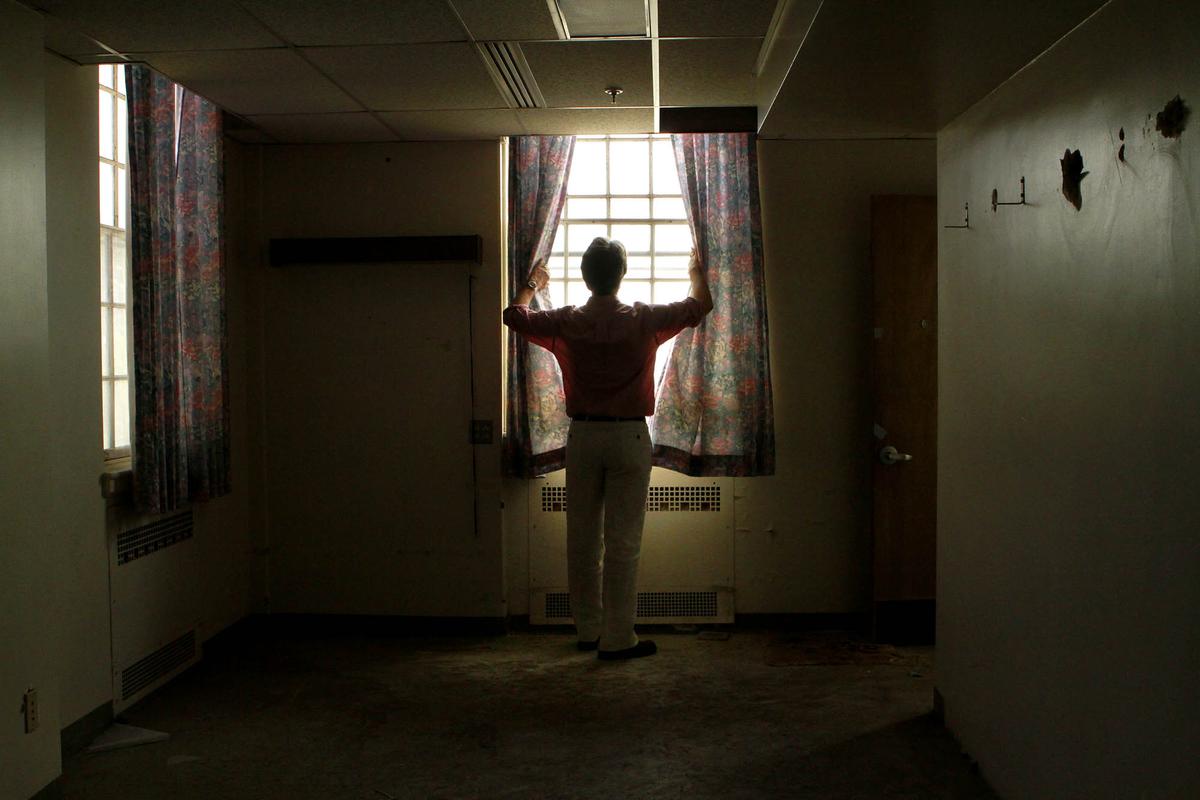 Bobby Shriver looks through a window at the West LA VA.