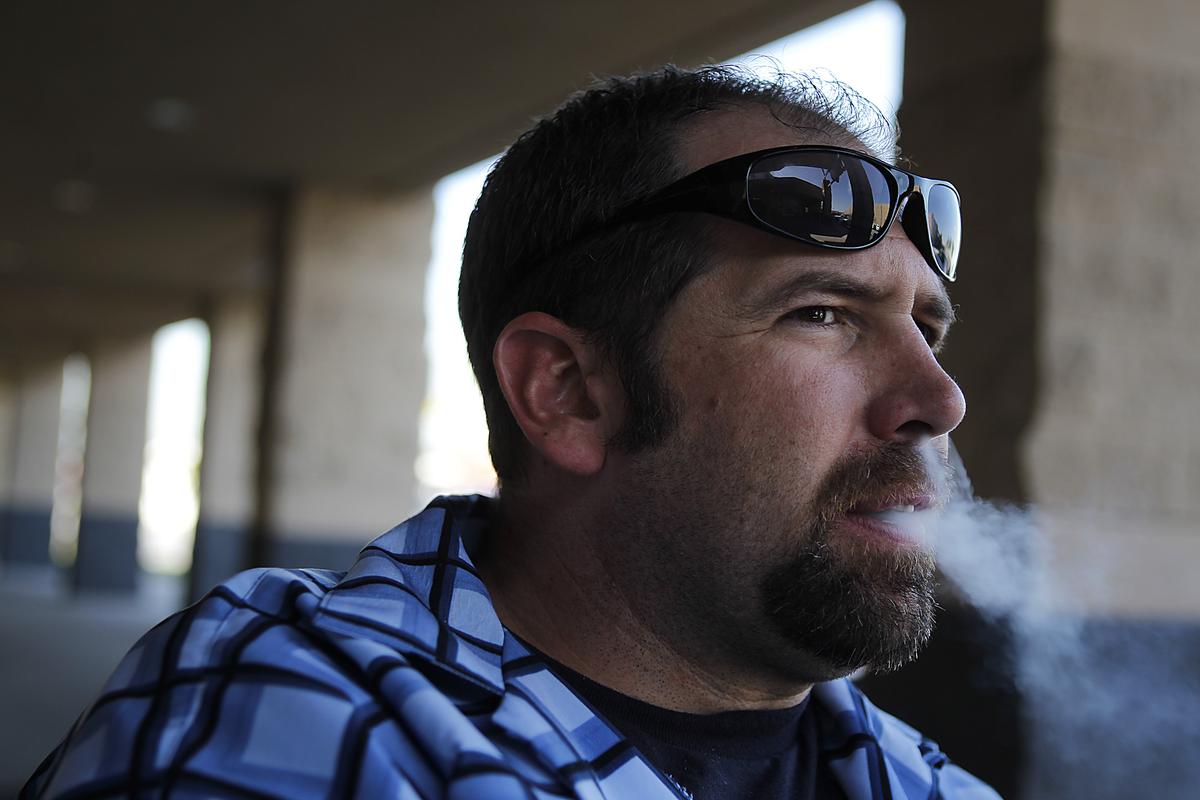 Afghanistan war veteran Greg Valentini smokes outside Cal Bowl in Lakewood.