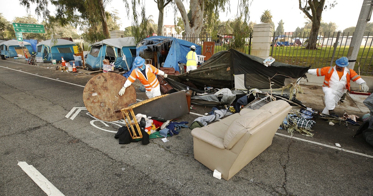 Members of a clean-up crew dismantle tents on the Veterans Row homeless encampment along San Vicente Boulevard just outside the West LA VA campus in November 2021.